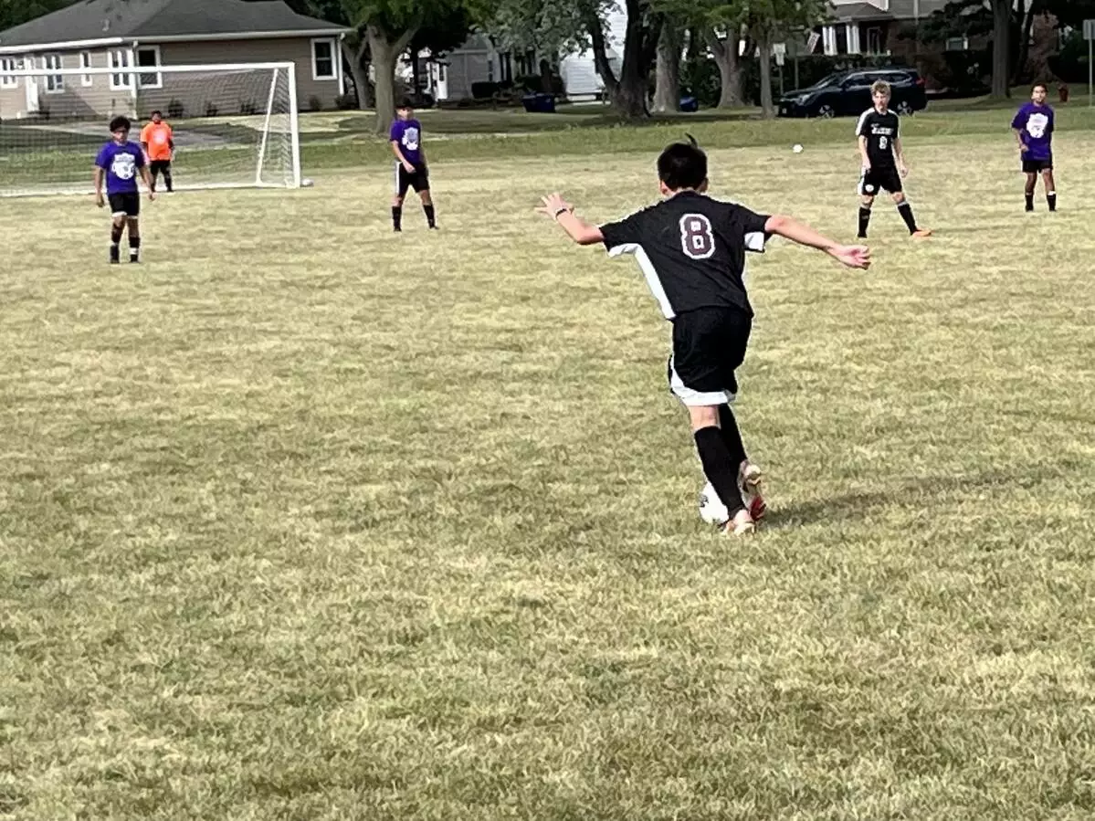 Player getting ready to strike the ball towards the goal.